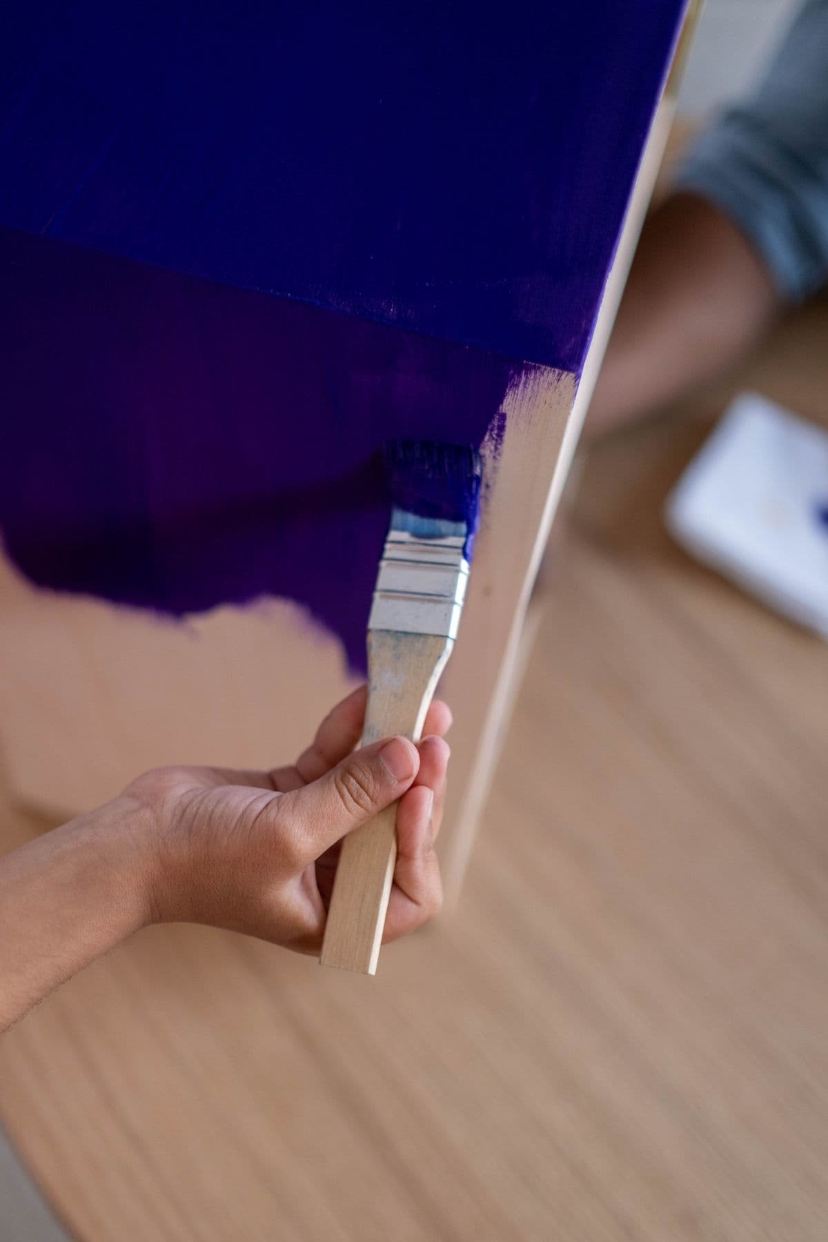 Illustrative stock photo of a hand painting with a brush